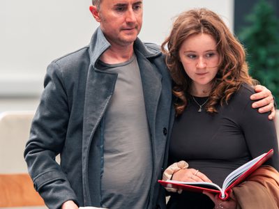Actor Ewan Donald has his arm comfortingly around the shoulders of actress Holly Howden Gilchrist. The pair seem sad and muted.