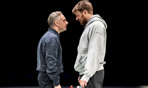 Jack and Martin stand face-to-face. They seem tense. Martin looks as though he is taunting Jack.